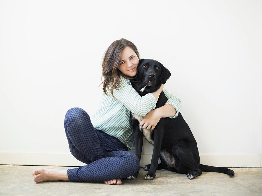 Portrait of woman with black dog Photograph by Tetra Images/Jessica Peterson