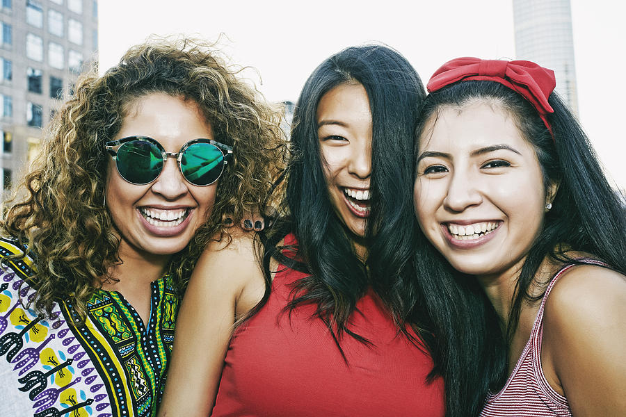 Portrait of women smiling on urban rooftop Photograph by Peathegee Inc
