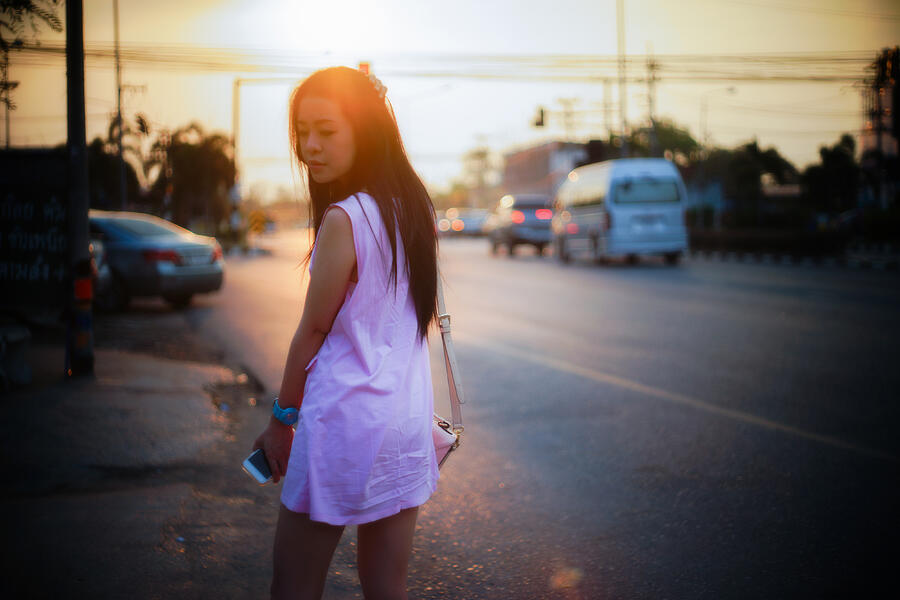 Portrait of young asian woman standing side of street Photograph by IttoIlmatar