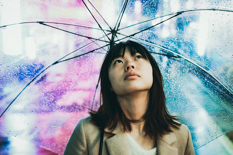 Portrait of young asian woman under raining in the night city Photograph by Kyonntra