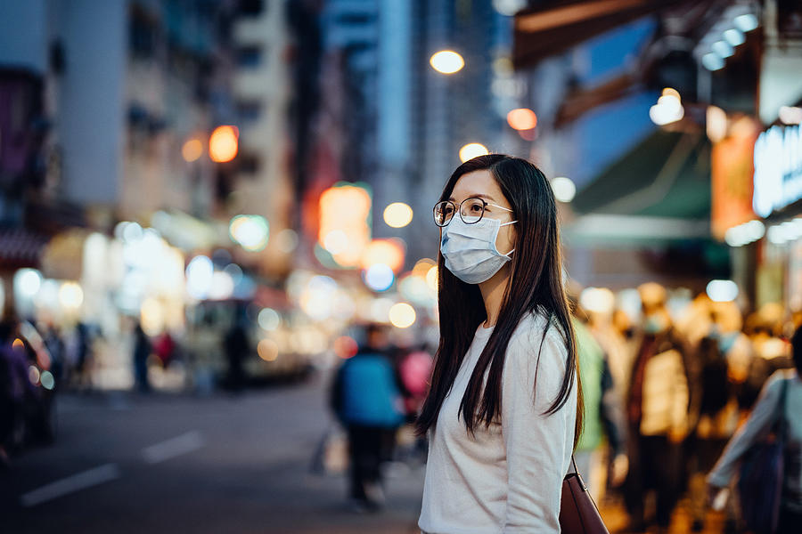 Portrait of young Asian woman with face mask to protect and prevent from the spread of viruses in the city Photograph by D3sign