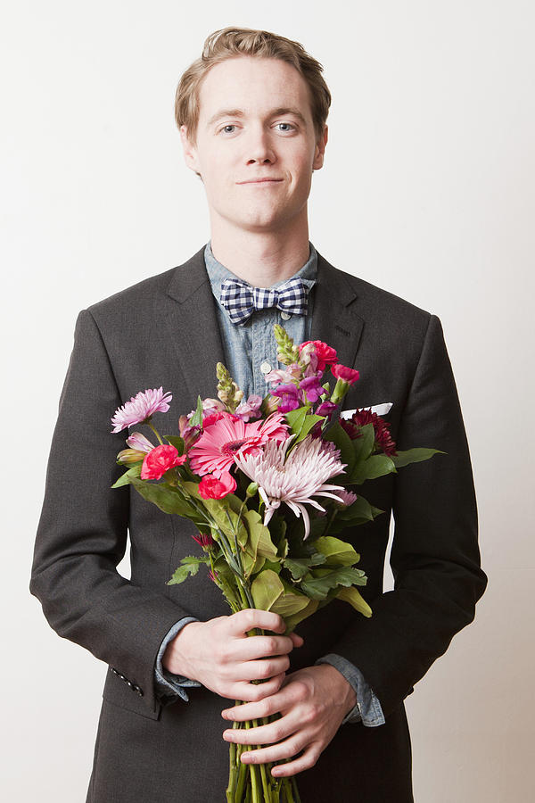 Portrait of young handsome man holding bunch of flowers Photograph by Jessica Peterson