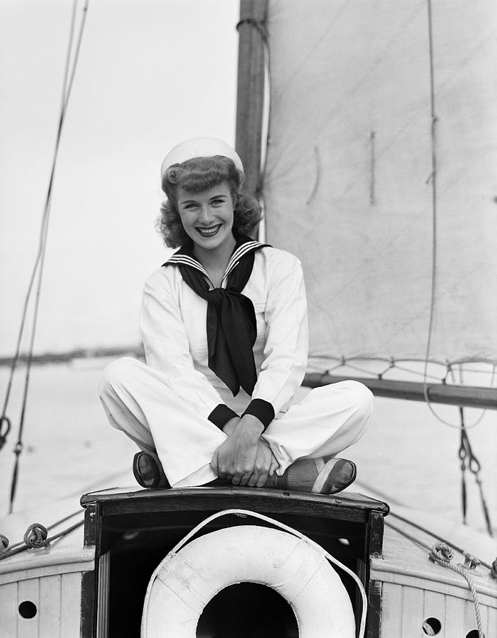 Portrait of young woman in sailor suit on ship Photograph by George Marks
