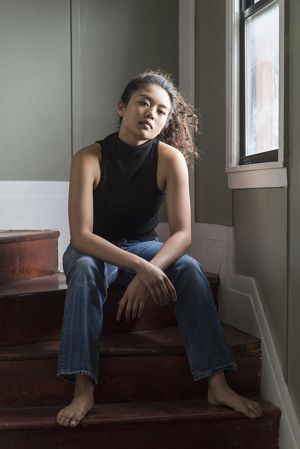 Portrait of young woman sitting on stairs Photograph by Tony Anderson