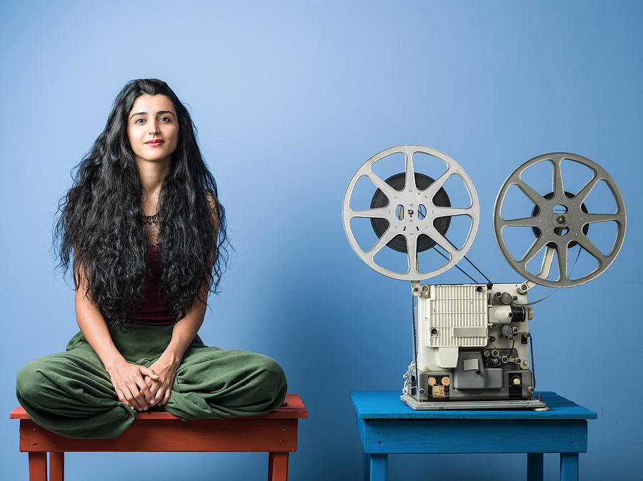 Portrait Of Young Woman With Long Black Hair Posing With Film Projector Photograph by Selimaksan