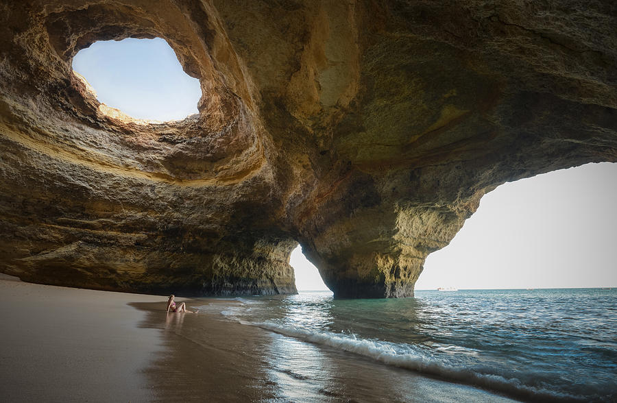 Portugal, beach of Benagil, cave, woman sitting at seafront Photograph by Westend61