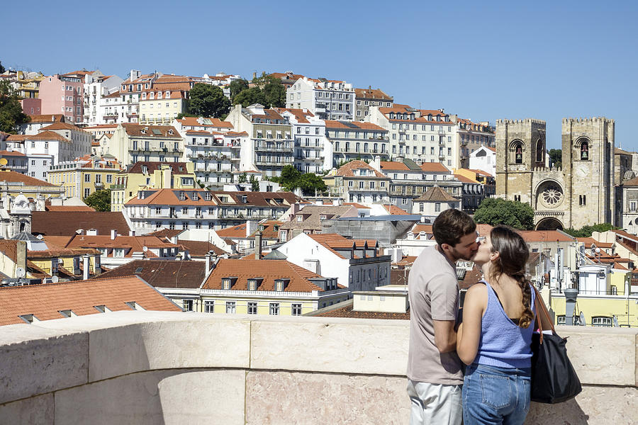 Portugal, Lisbon, Baixa, Chiado, historic district, couple kissing with city view behind Photograph by Jeff Greenberg Portugal, Lisbon, Baixa, Chiado, historic district, couple kissing with city view behind Photograph by Jeff Greenberg