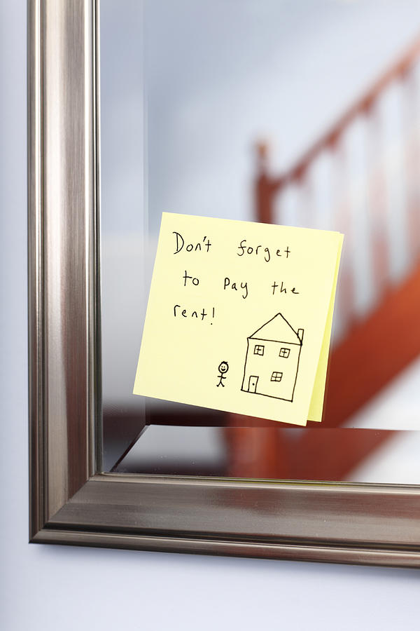 Post-it note with rent reminder on mirror Photograph by Tom and Steve