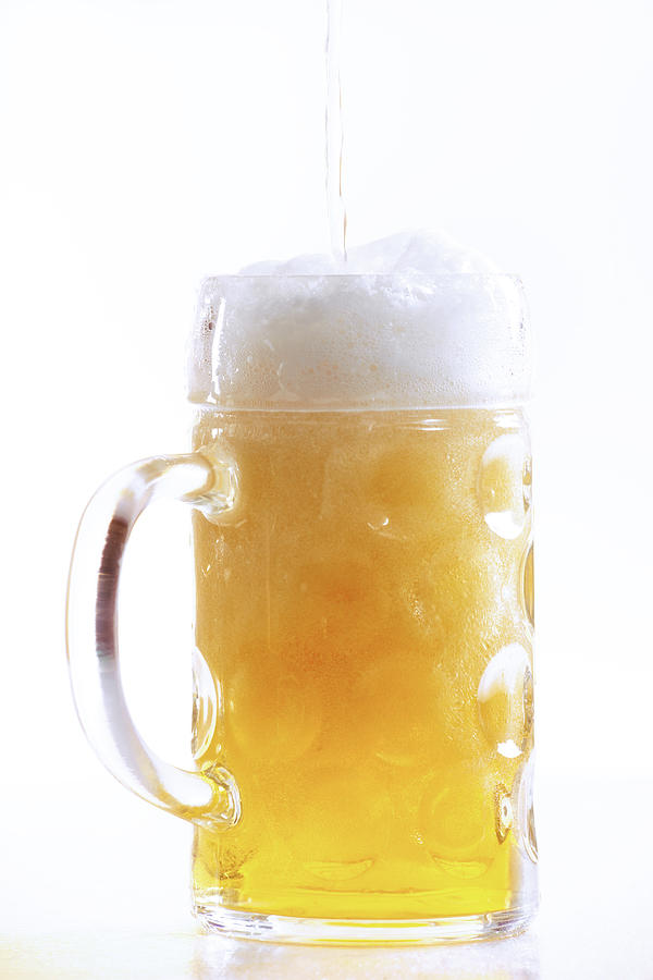 Pouring beer into glass, close-up Photograph by Creativ Studio Heinemann