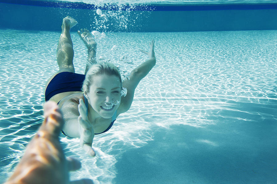 POV Happy young woman swimming underwater Photograph by Gary John Norman