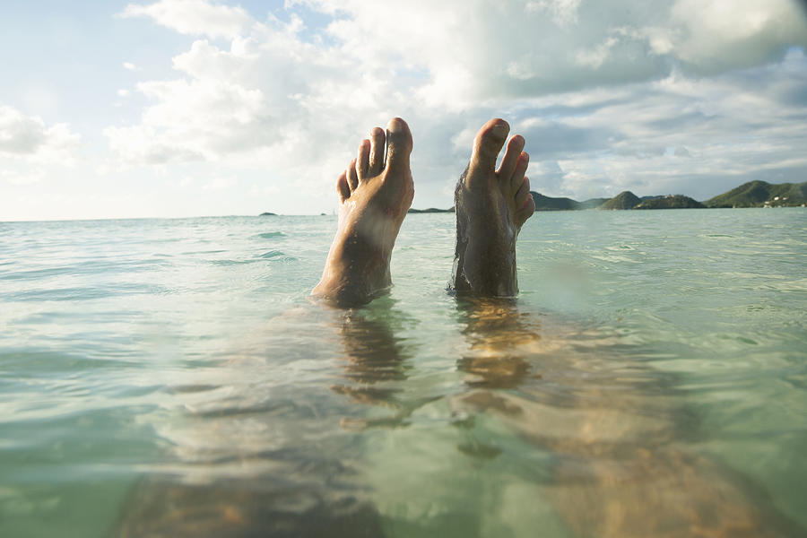 POV Man floats in tropical sea, feet out of water Photograph by Gary John Norman