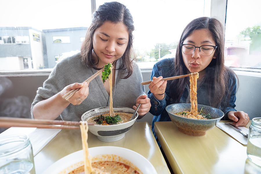 POV, Mixed-Ethnic Sisters Eating Vegan Japanese Ramen Noodle Soup in Diner Photograph by PamelaJoeMcFarlane