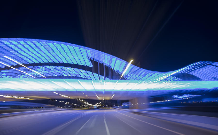 POV of a car approaching a blue illuminated bridge Photograph by Emanuel M Schwermer