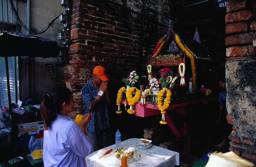 Praying at spirit house on Th Phra Athit, Banglamphu. Photograph by Lonely Planet