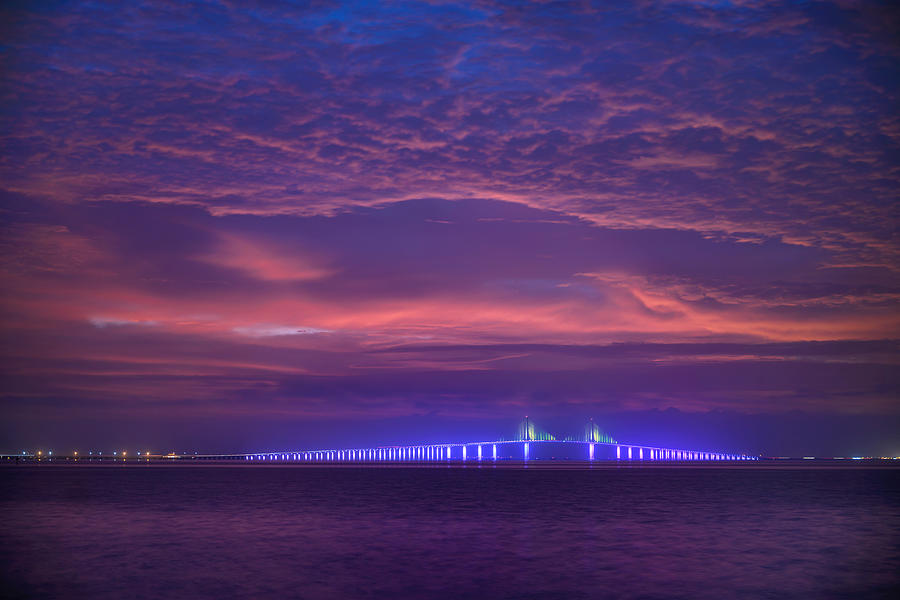 Pre-dawn clouds over the illuminated Sunshine Skyway Bridge, Fort De Soto Park, St. Petersburg, Florida Photograph by Diana Robinson Photography