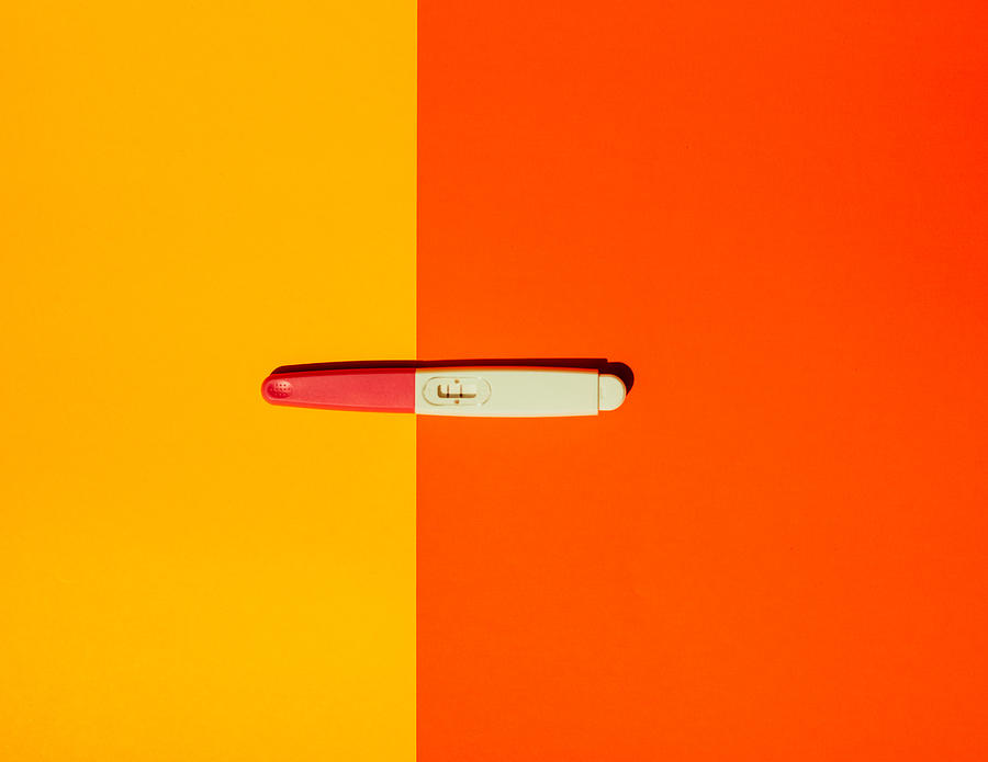 Pregnancy test on yellow background. Photograph by Guido Mieth