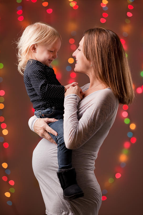 Pregnant Mother And Daughter At Christmas Photograph by Sdominick