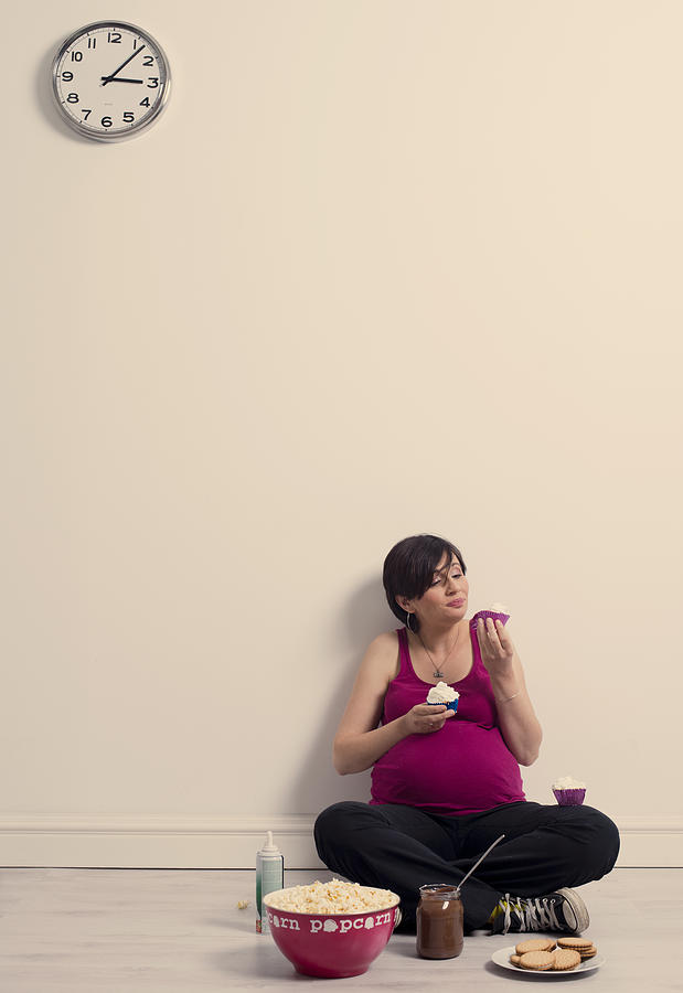 Pregnant woman eating  unhealthy food Photograph by Vesnaandjic