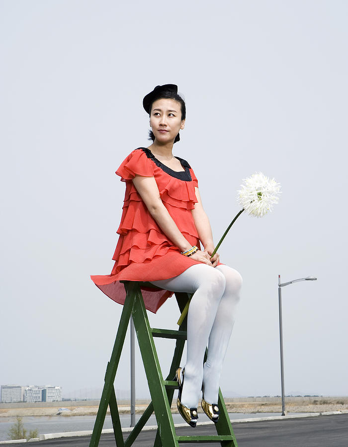 Pregnant woman on ladder with flower Photograph by Dae Seung Seo