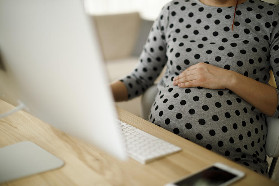 Pregnant woman working from home office Photograph by Damircudic