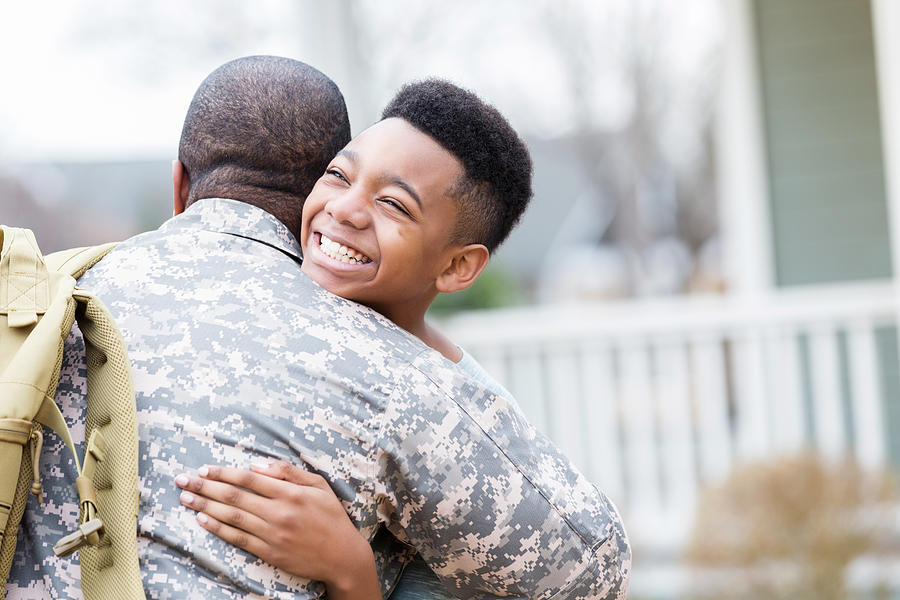 Preteen boy reunites with military dad Photograph by SDI Productions