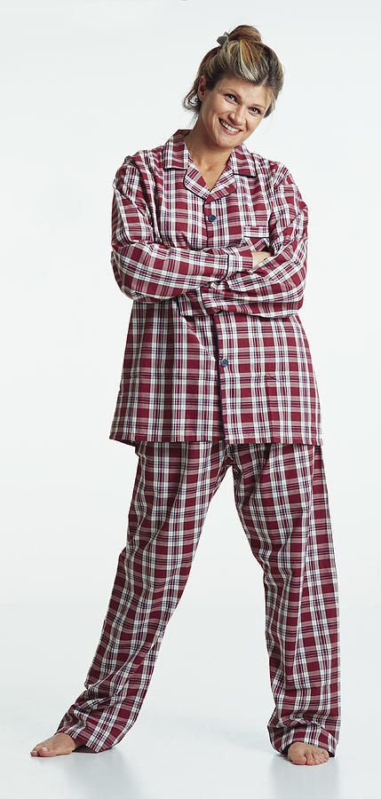 Pretty Young Caucasian Adult Blonde Female Barefoot With Hair Up Wearing Red Plaid Pajamas Stands With Arms Folded Looking At The Camera With A Humorous Smile Photograph by Photodisc