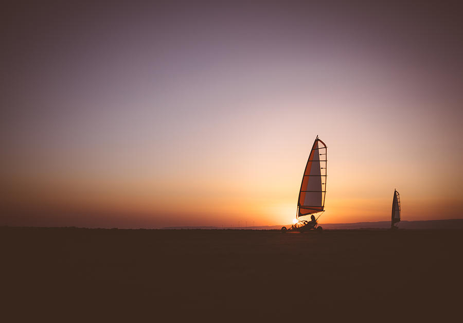 Professional land sailing athletes competing at beach competition Photograph by Wundervisuals