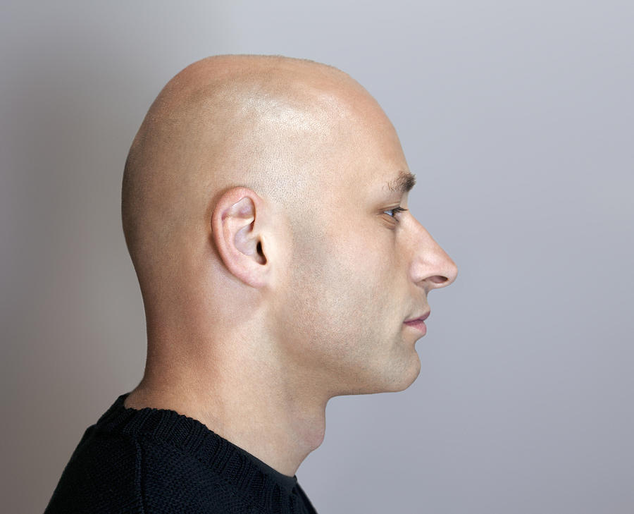 Profile headshot of a bald man with his eyes closed Photograph by Thinkstock