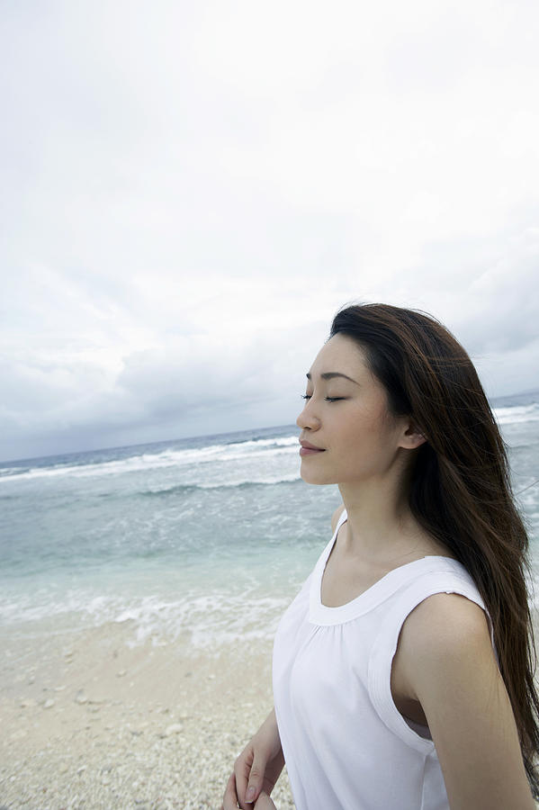Profile of a Woman Standing on a Beach With Her Eyes Closed Photograph by Dex