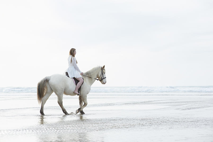 Profile of woman on horse at beach Photograph by Dougal Waters