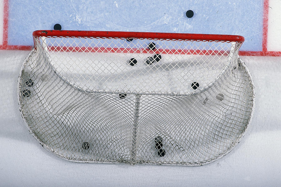 Pucks In The Goal Photograph by J McIsaac