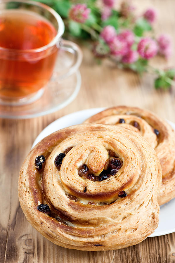 Puff buns with raisin and cup of tea Photograph by Darkbird77