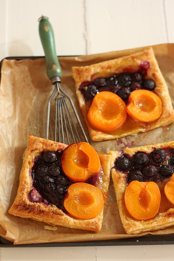 Puff pastry slices with apricots and blueberries Photograph by Image Professionals GmbH