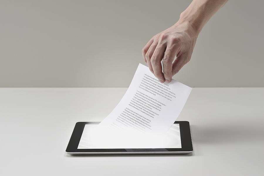 Pull Documents Out Of Digital Tablet Photograph by Yagi Studio