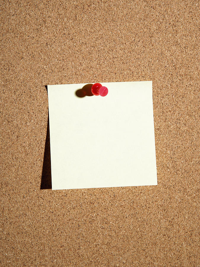 Push pin attaching adhesive note to cork board Photograph by Steven Puetzer