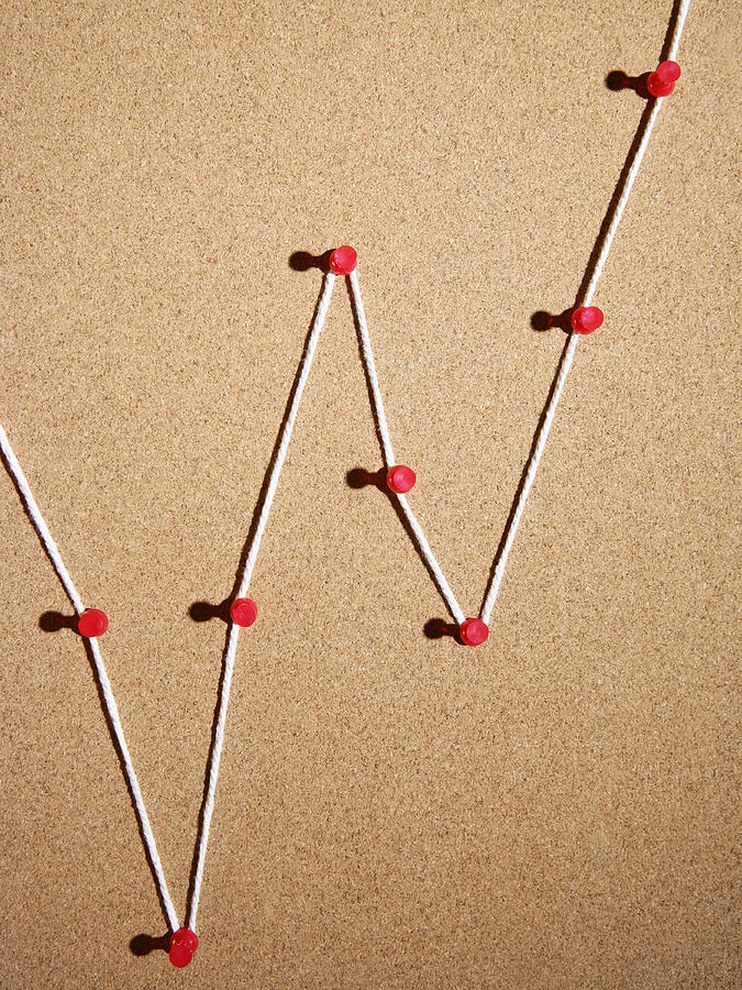 Push pins and string on cork board Photograph by Steven Puetzer