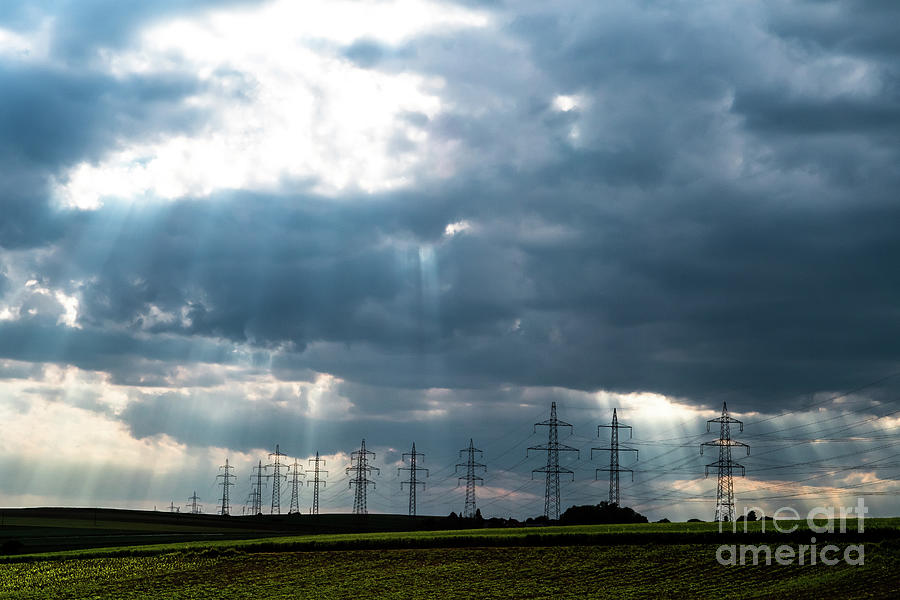 Pylons With High Voltage Energy Wires In Farmland At Stormy Weather Photograph