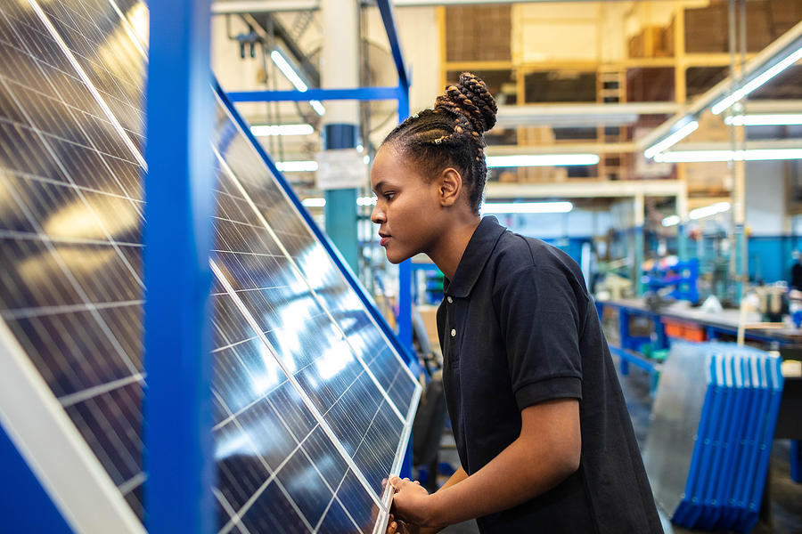 Quality engineer examining solar panels in factory Photograph by Alvarez