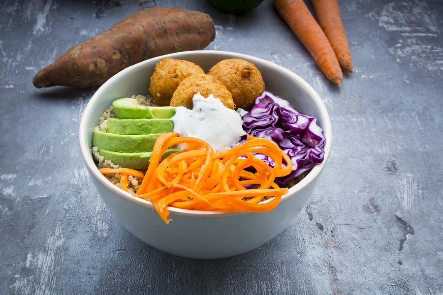Quinoa lunch bowl with sweet potato falafel, carrots, red cabbage, avocado and yoghurt sauce Photograph by Larissa Veronesi