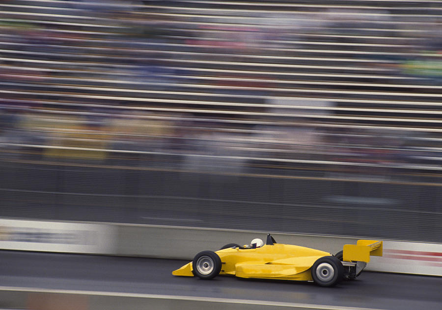 Racing car on track (blurred motion) Photograph by Grant Faint