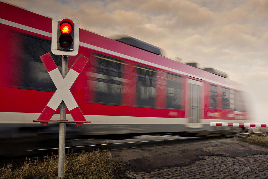 Railroad Crossing With Train in Motion Blur Photograph by Bernd Schunack