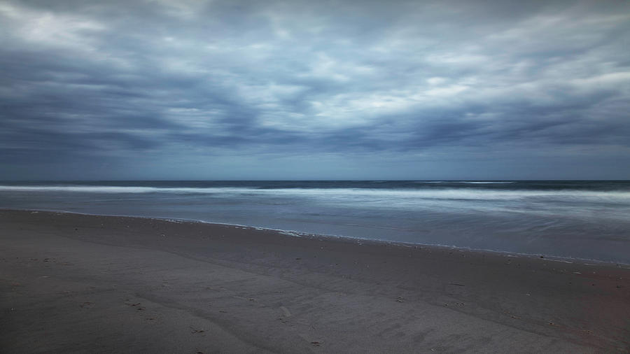 Rain Clouds along the beach Photograph by Steve Gravano