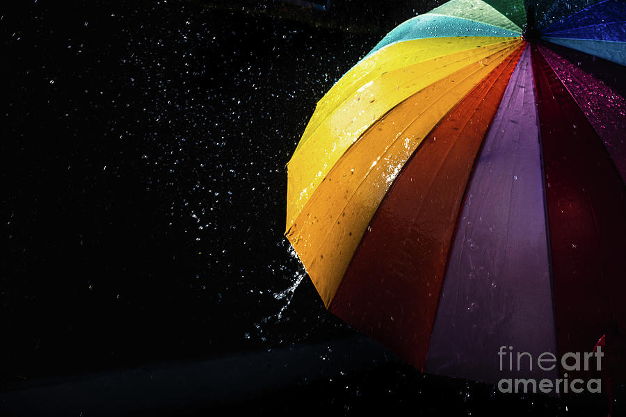 Rain on a warm-toned umbrella lit by the sun, isolated on black  Photograph by Joaquin Corbalan