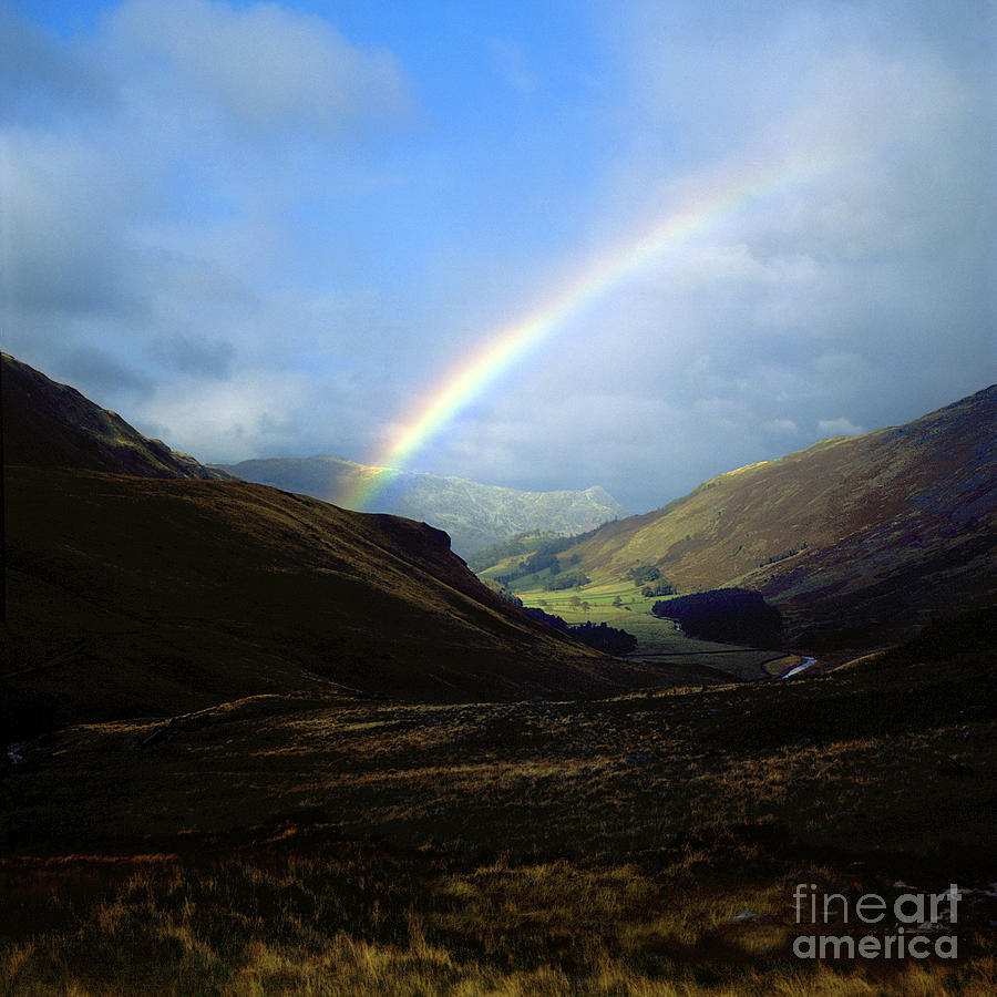 Rainbow in mountain valley Photograph by Robert Douglas