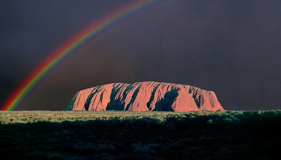 Rainbow over Ayers Rock, Australia Photograph by Buddy Mays
