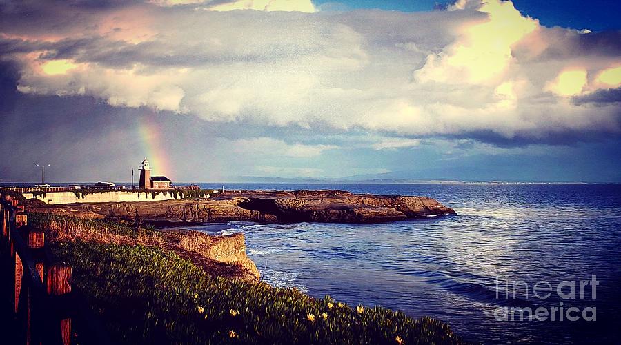 Rainbow over lighthouse  Photograph by Garnett Jaeger