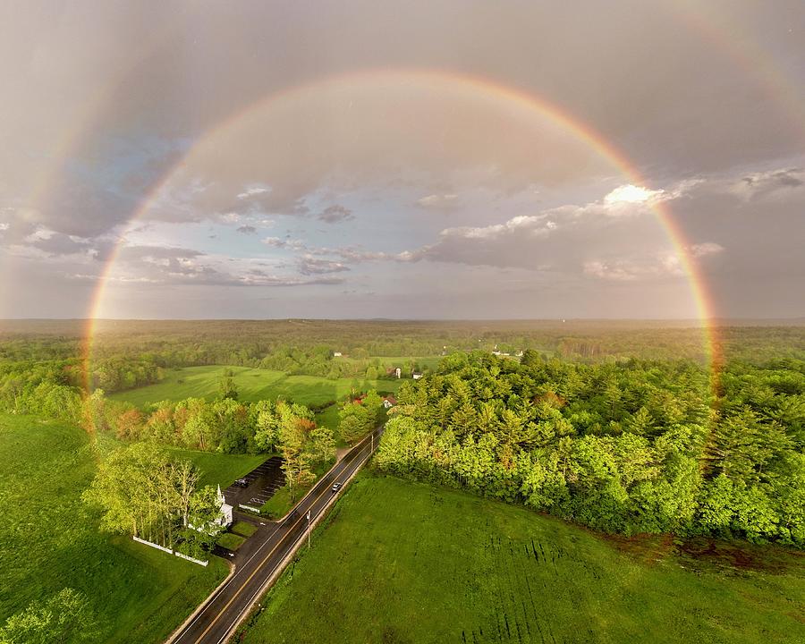 Rainbow over little white church  Photograph by John Gisis