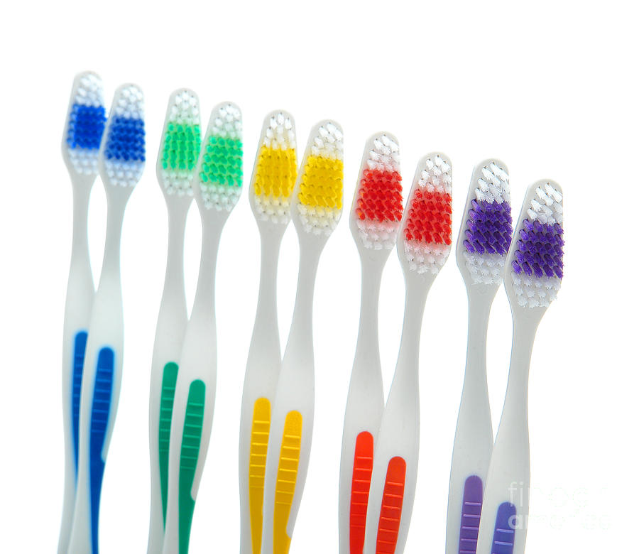 Rainbow Toothbrushes Isolated on White Photograph by Olivier Le Queinec