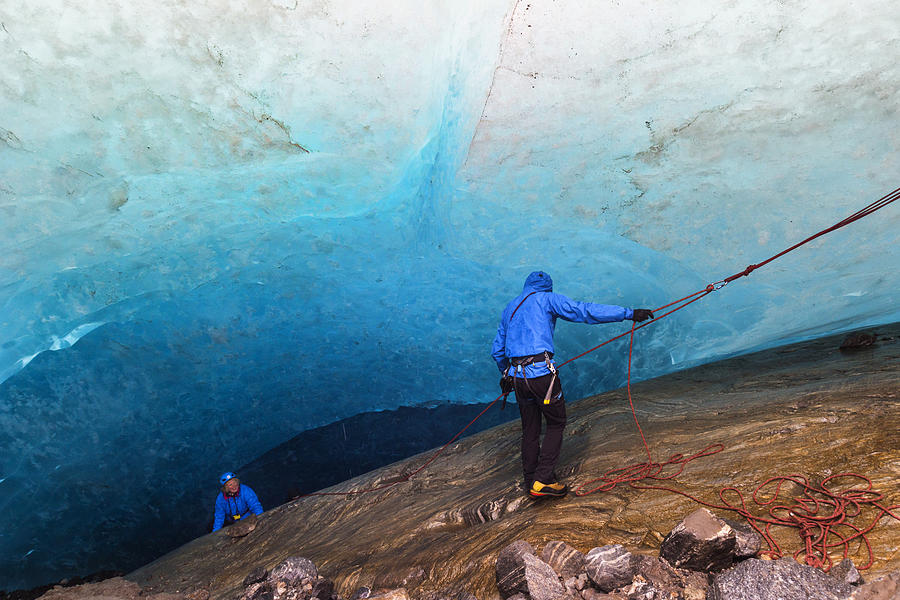Rappelling into an ice cave Photograph by Wanderluster