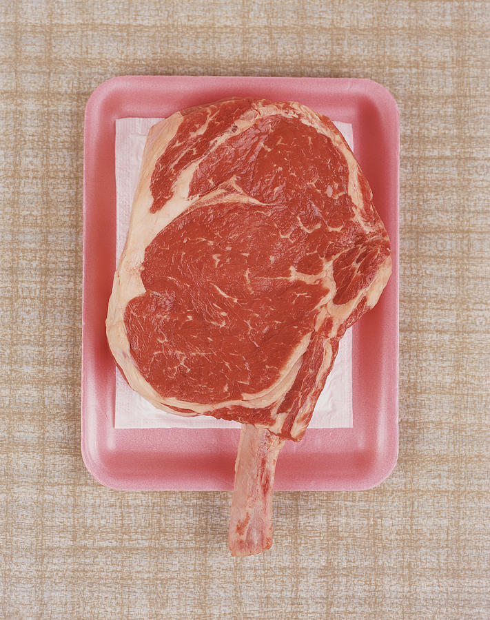 Raw Piece of Meat on Pink Tray Photograph by Digital Vision.